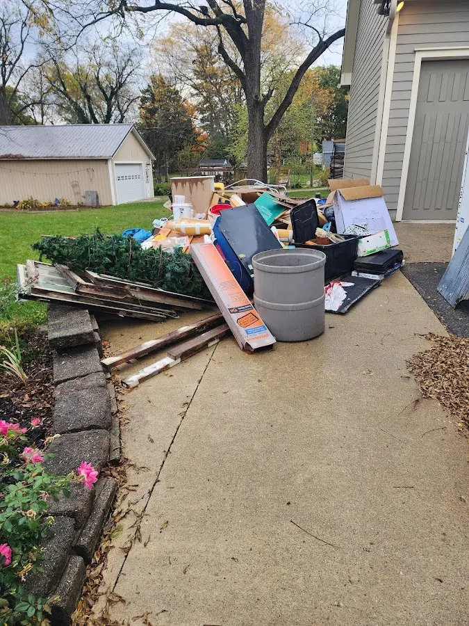Dumpster being loaded with debris for Estate Cleanout Dumpster Rental in Hendron
